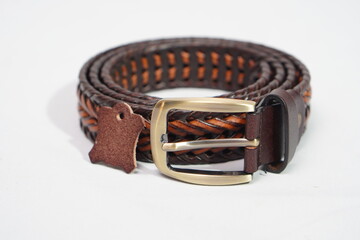 Rustic braided brown and tan leather belt with a bold brass buckle, a statement piece.