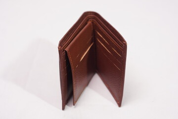Open brown textured leather wallet, showcasing its multiple card slots and minimalist, functional design.