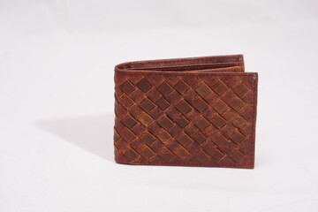 Stylish brown woven leather wallet with an intricate basketweave texture, combining craftsmanship and function.