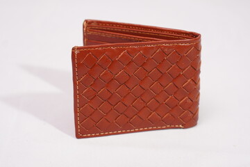 Open brown woven leather wallet, showcasing its intricate basketweave design and durable stitched...