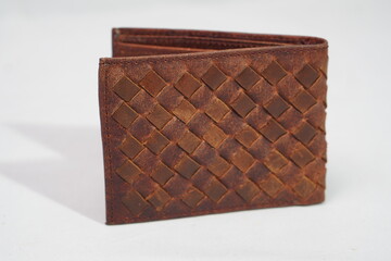 Stylish brown woven leather wallet with an intricate basketweave pattern, combining durability with classic aesthetics
