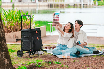 Asian Couple Watching Film Negatives Outdoors