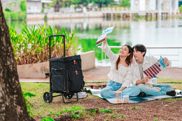 Asian Couple Watching Film Negatives Outdoors