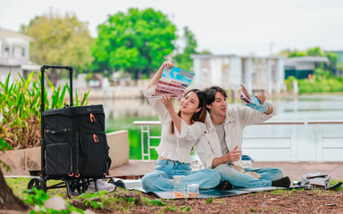 Asian Couple Watching Film Negatives Outdoors