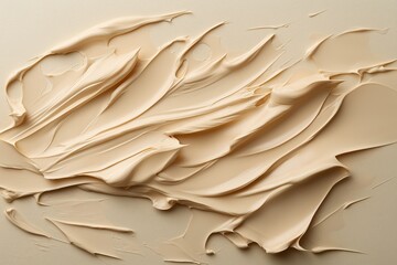 Close-up of cream texture on beige surface with abstract artistic brush strokes