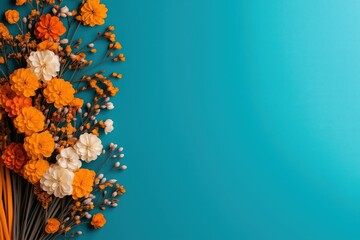 Bright orange and white flowers on a blue background with ample copy space.