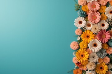 Colorful floral arrangement on blue background with various vibrant blooms in focus