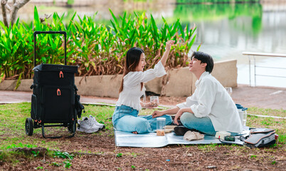 Asian Couple Sharing Snacks Outdoors