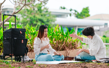 Asian Couple Playing Chess Outdoors