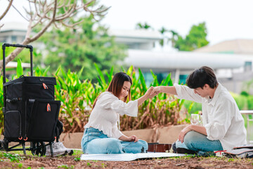 Asian Couple Playing Chess Outdoors