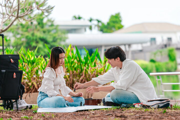 Asian Couple Playing Chess Outdoors