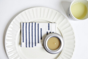 A white plate with a blue and white striped napkin on it.
