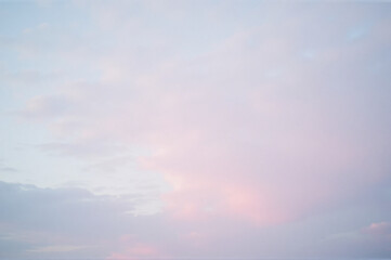 View of a cloudy sky with a pink cloud in the middle