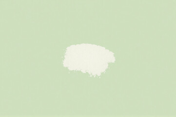 A white stain on a light green background.