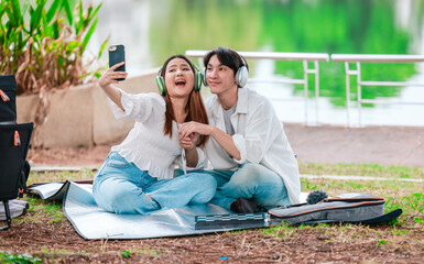 Asian Couple Enjoying Music Outdoors