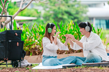 Asian Couple Enjoying Music Outdoors