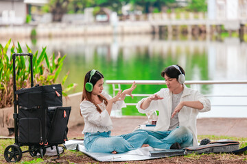 Asian Couple Enjoying Music Outdoors