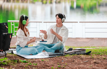 Asian Couple Enjoying Music Outdoors