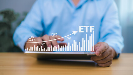 Investor using tablet to analyze ETF growth chart, representing financial success, smart investment strategy, stock market performance, and wealth building through exchange traded funds.