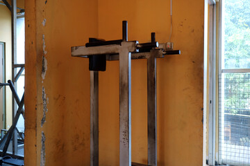 Worn Out Gym Dip Station Against Yellow Wall