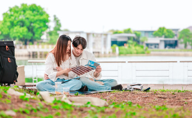 Asian Couple Watching Film Negatives Outdoors