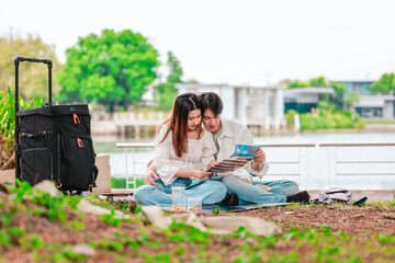 Asian Couple Watching Film Negatives Outdoors