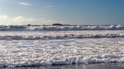 Whitecaps from outgoing waves on the beach