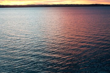 Red Evening Sky Reflected in Calm Ocean Surface