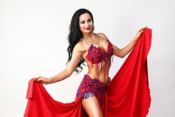 Elegant Eastern Dancer Gracefully Holding the Edges of Her Skirt in a Captivating Performance.