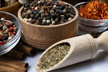 Spices in wooden and glass bowls close-up.