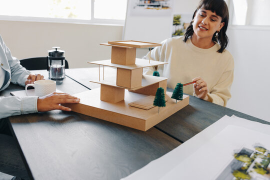 Collaborative team meeting for architecture model planning in a modern office.