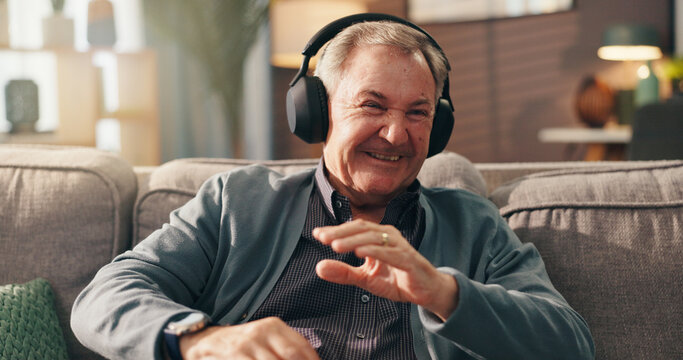 Retirement, laugh and old man with headphones, relax and listen to podcast on break and living room. Happy, pensioner and elderly person with humor in house, radio and subscription for show on web