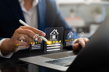 Businessman using digital pen on laptop give five-star rating for real estate property,Representing house evaluation,Online feedback,Smart technology,Digital service review in the real estate market
