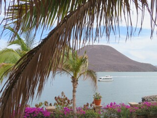 tropical beach of sea of Cortez with mountains, yacht, palms, Mexico