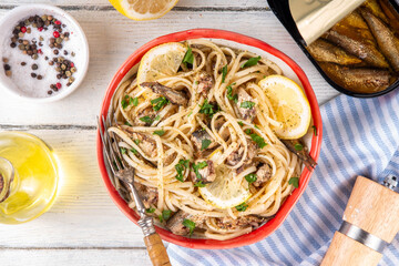 Sardinecore trend food, sardine pasta for dinner in plate on kitchen table. Spaghetti pasta with...