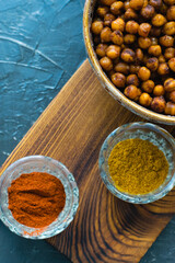 Delicious snack, fragrant baked with curry spices and smoked paprika chickpeas in a brown bowl and...