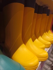 Bright yellow rubber boots on store shelves