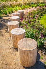 Cozy seating area in a park, garden or patio made from natural wooden logs