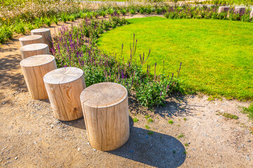 Cozy seating area in a park, garden or patio made from natural wooden logs