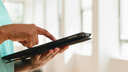 Close-Up of a Person Using a Tablet Device in a Modern Bright Environment © Meeko Media
