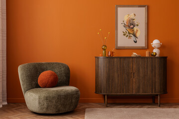 Modern space with olive green armchair, warm wood cabinet and framed mock up print featuring a bird...