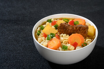 Delicious Beef Stew with Pasta and Vegetables in a White Bowl