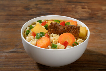 Delicious Beef Stew with Pasta and Vegetables in a White Bowl