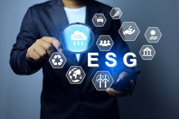 ESG concept environmental social governance with businessman using magnifying glass to search for  activity co2 emission reduction in leading company take care the environment