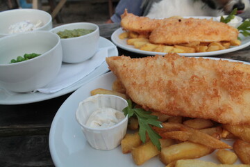 British traditional fish and chips with mushy peas and tartare sauce, close-up