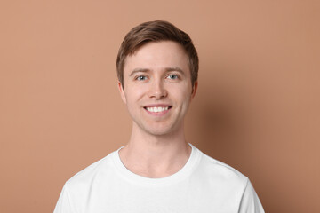 Handsome man after shaving on beige background