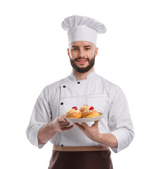 Happy confectioner in uniform holding delicious profiteroles with strawberries on white background