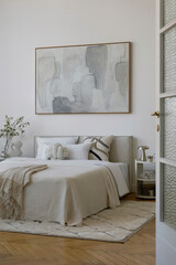 Contemporary bedroom with geometric pillows, neutral bedding, and sculptural accessories.