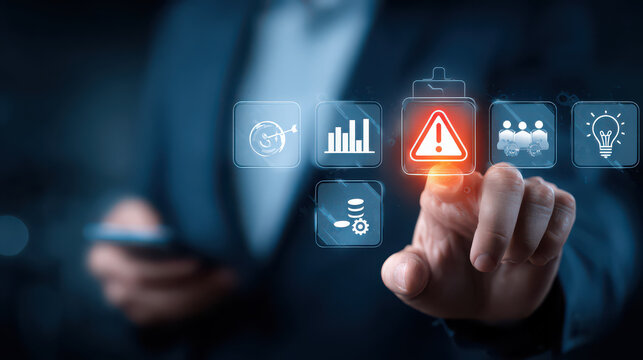 Businessman touching warning icon, risk management, data analysis