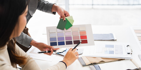 Close up on hands of Female interior designer teamwork selects new painting colors and finishing material , develops future interior design projects.